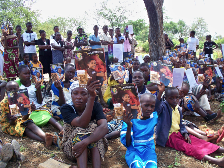 Believers in Kenya having a church meeting underneath a tree using materials from Urban Ministries, Inc.